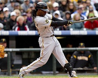 Pittsburgh Pirates' Andrew McCutchen (22) hits an RBI single, scoring Perdro Alvarez, on a pitch by Colorado Rockies' Esmil Rogers, during the fifth inning of a baseball game Sunday, May 1, 2011 in Denver. The Pirates won 8-4.