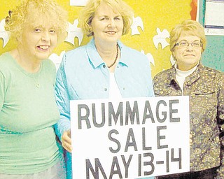 Sign says it all: The Women’s Altar and Rosary Guild of St. Thomas the Apostle Catholic Church, 4453 Warren-Sharon Road, Vienna, will sponsor a rummage sale from 10 a.m. to 5 p.m. May 13 and 14. At 2 p.m. Saturday, all merchandise will be half-price. On both days, clothing will be sold for $3 per grocery bag. Some items will be prepriced. Also featured will be a bake sale, a light lunch for sale, free admission and free parking. From left to right, above, are Ann Bosheff, chairwoman of the bake sale; Patty Slavin, project chairwoman; and Barb Obermiyer, kitchen assistant chairwoman.