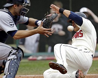 Cleveland Indians' Shin-Soo Choo, right, scores as Detroit Tigers catcher Alex Avila, left, waits for the ball in the eighth inning of a baseball game on Sunday, May 1, 2011, in Cleveland. Choo scored on a single by Orlando Cabrera. The Indians won 5-4.