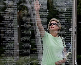 Kathy Maycen reaches to touch the name of her daughter, Lindsay Stapleton Morehouse, who was killed in the attack on the World Trade Center on Sept. 11, 2001, at a memorial in Palm Beach Gardens, Fla., Monday May 2, 2011. Osama bin Laden, the face of global terrorism and architect of the Sept. 11, 2001, attacks, was killed in a firefight with elite American forces in Pakistan on Monday, then quickly buried at sea in a stunning finale to a furtive decade on the run. (AP Photo/The Palm Beach Post, Lannis Waters) ** MAGS OUT. TV OUT. NO SALES **