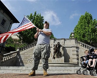 In celebration of the announcement that Osama Bin Laden was killed, Iraq veteran Jesse Macdonald waves an American flag at Monument Terrace with his two sons on Church Street in downtown Lynchburg, Va. on Monday, May 2, 2011. "When we say our prayers, [my daughter] always adds in, 'And may they catch the bad guys.' Today I told her, 'Last night they got the number one bad guy,'" said Macdonald. 