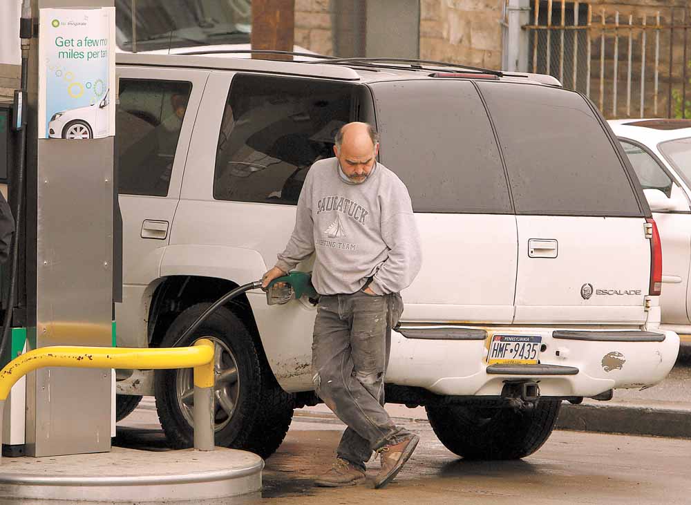 A man pumps gas at a BP gas station Tuesday, May 3, 2011 in Pittsburgh, where regular gas was priced at $4.05, medium at $4.25, and hi-test $4.39. The national average for a gallon of regular was $3.97 on Tuesday _ 32 cents higher than a month ago and $1.07 more than a year ago. 