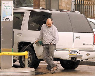A man pumps gas at a BP gas station Tuesday, May 3, 2011 in Pittsburgh, where regular gas was priced at $4.05, medium at $4.25, and hi-test $4.39. The national average for a gallon of regular was $3.97 on Tuesday _ 32 cents higher than a month ago and $1.07 more than a year ago.