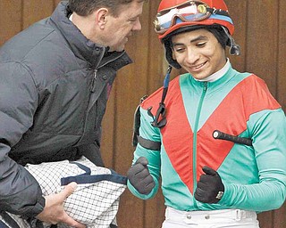 Trainer H. Graham Motion, left, shares a laugh with jockey Alan Garcia before he rode Animal Kingdom to a two-length victory in the $500,000 (Gr. III) Spiral Stakes horse race at Turfway Park race course in Florence, Ky., Saturday, March 26, 2011.
