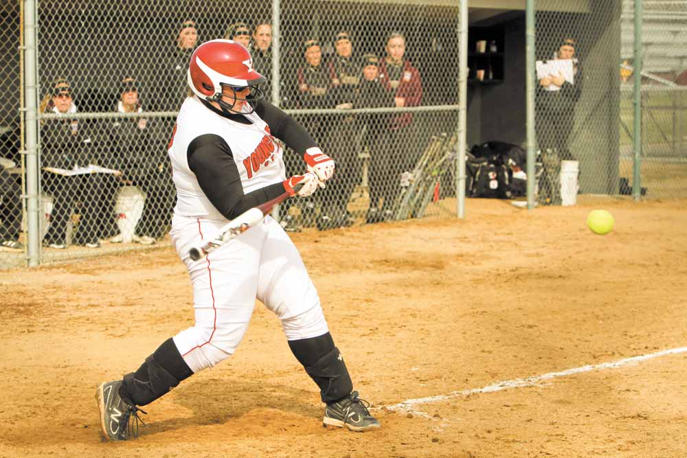 Sarah Ingalls shortens up her swing to drive a pitch during a YSU softball game. Sarah, who is distantly related to “Little House on the Prairie” author Laura Ingalls Wilder, said the hardest part about a prairie lifestyle would be giving up modern conveniences such as Facebook.