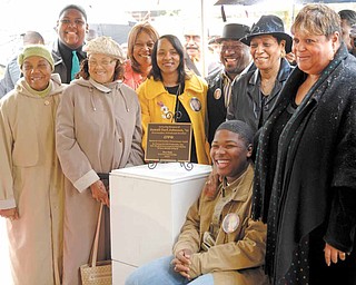 Family members of Jamail Johnson gather around the plaque that will rest under the tree planted in Johnson’s memory. The plaque was dedicated by Johnson’s fraternity, Omega Psi Phi, Woodrow Wilson Middle School and the Youngstown State University Student Government Association.