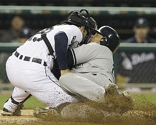 New York Yankees' Andruw Jones, right, is tagged out by Detroit Tigers catcher Alex Avila (13) during the fourth inning of a baseball game, Tuesday, May 3, 2011, in Detroit.