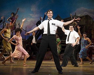 In this theater publicity image released by Boneau/Bryan-Brown, Andrew Rannells, center, performs with an ensemble cast in "The Book of Mormon" at the Eugene O'Neill Theatre in New York. "The Book of Mormon" nabbed a leading 14 Tony Award nominations Tuesday morning, earning the profane musical nods for best musical, best book of a musical, best original score, two leading actor spots and two featured actor nominations.