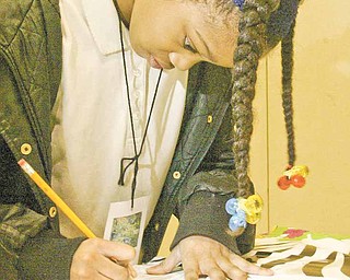 William d Lewis the Vindicator Taylor Lofton , 3rd grade, works on a project during a family night at Taft School Wed. Curtis is a kindergarten student at Taft
