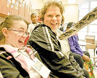 Third-grader Shaylynn Montero and her mother Katrina Montero, both of Youngstown, check out a Burmese python during Family Night. Jungle Terry, also known as Terry Sullivan of Ashtabula, brought the snake.