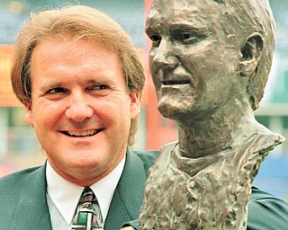 Former Mets relief pitcher Edwin "Tug" McGraw poses with a bronze bust of himself after he was inducted in the New York Mets Hall of Fame at Shea Stadium, New York, September 26, 1993.