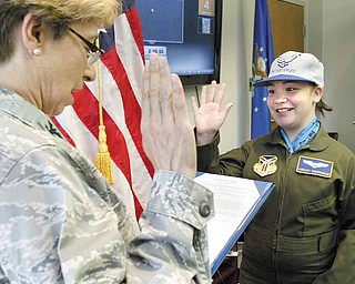 Ashley Moorhead, 11, of Warren, is sworn in as an honorary Air Force second lieutenant by Air Force Reserve Col. Teresa Ham during the 910th Airlift Wing’s Pilot for a Day program.