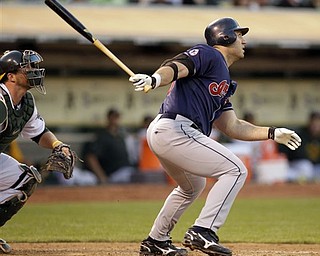 Cleveland Indians' Travis Hafner watches his RBI single hit off Oakland Athletics' Trevor Cahill during the third inning of a baseball game, Wednesday, May 4, 2011, in Oakland, Calif.