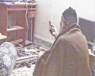In this undated image taken from video provided by the U.S. Department of Defense, a man who the American government says is Osama bin Laden watches television in a video released on Saturday, May 7, 2011. The videos show bin Laden watching himself on television and rehearsing for terrorist videos.