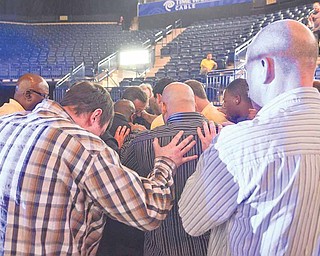 A group of men gather to pray at the Covelli Centre in downtown Youngstown during the second annual Men’s Rally in the Valley.