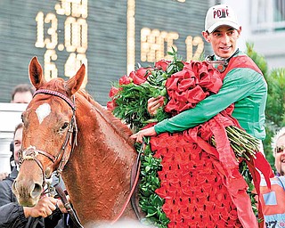 John Velazquez holds the Blanket of Roses after riding Animal Kingdom to victory during the 137th Kentucky Derby horse race at Churchill Downs Saturday, May 7, 2011, in Louisville, Ky.