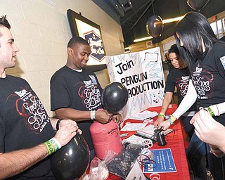 Penguin Productions members blow up black balloons as part of a pre-concert promotion for the April 12 Goo Goo Dolls show at Covelli Centre. From left are JD Kubacki, Dennis Pixley, Anastasia Seymour and Olivia Arnold.