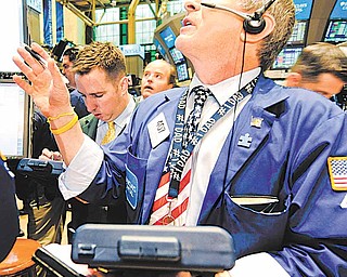 Richard Newman of Barclays Capital works on the floor of the New York Stock Exchange on the one year anniversary of the 'flash crash,' Friday, May 6, 2011, in New York.