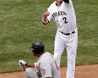 Pittsburgh Pirates third baseman Brandon Wood (2) leaps for a high throw from center field as Houston Astros' Carlos Lee slides safely into third during the eighth inning of a baseball game in Pittsburgh, Sunday, May 8, 2011. Lee advanced to third on a errant pickoff throw by Pirates pitcher Daniel McCutchen. The Pirates won 5-4.