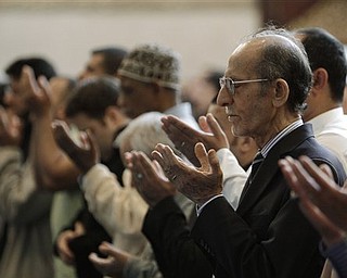 In this May 6, 2011 photo, Jebary Alsaade, right, and other Muslims prays at the Islamic Center of America in Dearborn, Mich. The killing of Osama bin Laden, a man who was America's face of evil for nearly a decade, left Christians, Jews and Muslims relieved, proud or even jubilant. For their religious leaders, it was sometimes hard to know just what to say about that. There is at least some dissonance between the values they preach and the triumphant response on the streets of New York and Washington to the death of a human being _ even one responsible for thousands of killings in those areas and around the world.