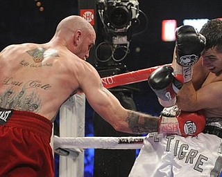 Kelly Pavlik lands a punch to the body against Alfonso Lopez in the fourth round during a WBO World super bantamweight title bout, Saturday, May 7, 2011, in Las Vegas. Pavlik won by unanimous decision.