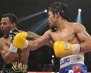Manny Pacquiao lands a punch against Shane Mosley in the ninth round during a WBO welterweight title bout, Saturday, May 7, 2011, in Las Vegas.