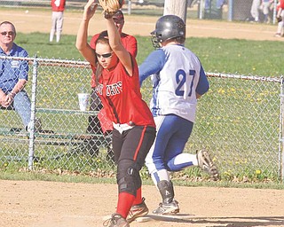 Struthers’ Mandy Ditman catches the ball before Hubbard’s Brittany Lunt can make it to the bag during Monday’s sectional opener in Hubbard.