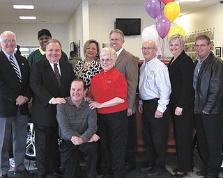Representatives of the Rotary Club of Canfield, Hospice of the Valley, Greenwood Chevrolet of Austintown and General Motors of Lordstown , who are helping with a raffle for a 2011 Chevy Cruze LTZ, are, standing from left, Gerry Finch, Tom Pauley, Marshall Coney Jr., Dante Zambrini, Liz McGarry, Dee Saunders, Greg Greenwood, Jack Saunders, Lynn Roman, Bill Hendricks and Craig Olson., and seated, Tom Mock.