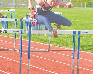 Miles Dunlap of McDonald High School clears a hurdle on his way to winning the boys 110-meter hurdles event during the Inter Tri-County League Tier 2 track meet Wednesday at Western Reserve High School in Berlin.