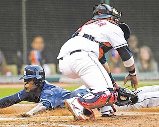 Tampa Bay Rays' B.J. Upton, left, slides safely into home plate as Cleveland Indians catcher Carlos Santana is late with the tag in the fourth inning in a baseball game, Wednesday, May 11, 2011, in Cleveland. Upton scored on a fielders choice by John Jaso.
