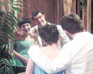 Bianca Severino and Mark Saraceno check out their reflections in a mirror at Antone’s Banquet Center in Boardman during a Special Needs Prom. About 150 attended the dance Thursday night.