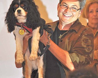 Children’s book illustrator Jenny Campbell of Chagrin Falls introduces Ollie, a King Charles cavalier spaniel, to students at Struthers Elementary School. They were there Thursday as part of a literacy program, along with author Sandra Philipson, who writes about her spaniels.