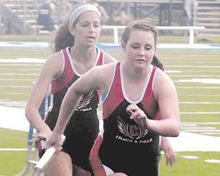Canfield’s Nicole Tiberio hands off to Kaylee Kilbert during the girls 4x800-meter relay at the All-American Conference Red Tier track and field meet at Poland High School on Thursday.Unfortunately, a torrential rain and lightning forced the cancellation of the annual event, and many other high school sports events in the area. The AAC Red track and fi eld meet, and the Inter Tri-County League Tier One track and field meet will not be rescheduled. The many baseball and softball tournament games scheduled for Thursday are rescheduled for today — provided Mother Nature doesn’t interfere again.
