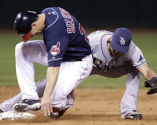 Cleveland Indians center fielder Grady Sizemore, left, slides safely into second base in the sixth inning in a baseball game against the Tampa Bay Rays, Tuesday, May 10, 2011, in Cleveland. Sizemore jammed his right knee, not the one he had season-ending microfracture surgery on in 2010, while sliding into second base in the sixth inning of Tuesday night's 5-4 victory over Tampa Bay, the Indians' 14th straight win at home. After being checked, he stayed in the game. However, the three-time All-Star had knee soreness on Wednesday, so the Indians' medical staff decided to have him undergo an MRI.