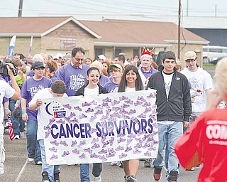RAMI DAUD | THE VINDICATOR.Cancer Survivors make the first lap around the track at the Boardman Center Middle School track Friday evening.