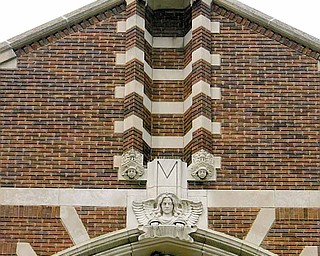 The edifice of St. Patrick Church, 1420 Oak Hill Ave., Youngstown, reaches toward heaven with a cross flanked by two angels. The brick and stone church in a Gothic design was dedicated in 1926. The first church was a California mission-style built in 1911.