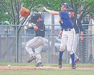 Canfield’s Anthony Ross (5) gets tangled up with Hubbard first baseman Austin Eppstein (4) during a Division II sectional championship baseball game Friday at Cene Park. The Cardinals dominated the Eagles, 12-2, and will face Niles on Wednesday.