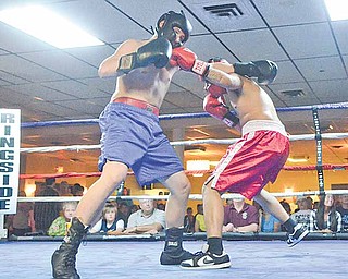 Demitryus Martinez of Struthers (in red) lands a punch to the face of Nick Lardas of Niles (blue) during their bout in the cruiserweight division of the K.O. Drugs Boxing Tournament on Friday at the ITAM Banquet Center in Youngstown. Martinez won the match.