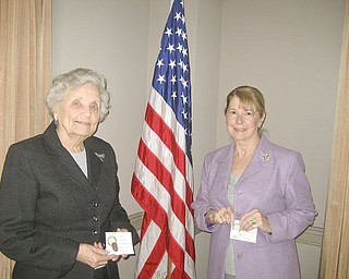 Gold pins, signifying 50 years of service to the Youngstown Area Federation of Women’s Club, were awarded at a recent meeting of the club to, from left, Lucile Bartelmay and Barbara Higgins.