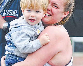 Angela Boelk, 29, of Medina hugs her son, Asher, at the finish line of the D.D. & Velma Davis Family YMCA’s Sprint Distance Triathlon on Sunday. The event attracted nearly 100 participants. Each contestant competed in a 500-yard swim, a 14.5-mile scenic bike ride and a 5K run at the branch’s Boardman facility on McClurg Road.