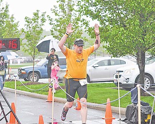 Victor Cushnick, 43, crosses the finish line at the Davis Family YMCA/ Steel Valley Tri Club Spring Distance Triathalon. 