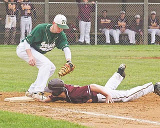South Range’s Cory Deal (20) makes it safely back to the bag ahead of the tag by Ursuline’s John McGeary (18)
during their Division III sectional final Monday at Cene Park in Struthers. After leading 5-4 in the top of sixth,
the Raiders gave up two runs in the bottom of the inning to give the Irish the 6-5 win.