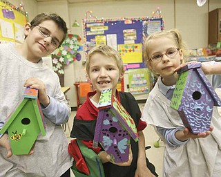 Mollie Kessler School students, from left, Paul Walker, Alex Ferguson and Natalie Rhinehart show off their finished birdhouses that they painted for Habitat for Humanity. The students studied homelessness in school.