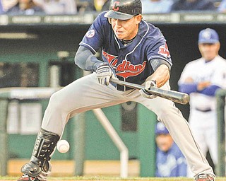 Cleveland Indians' Asdrubal Cabrera bunts during the first inning of a baseball game against the Kansas City Royals in Kansas City, Mo., Tuesday, May 17, 2011. The bunt advanced teammate Michael Brantley to third base.