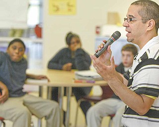 Author Jaime Adoff visits with students at Wilson Middle School in Youngstown on Tuesday as part of Right to Read Week. Sixth-grade students are reading Adoff’s book, “Jimi and Me,” recipient of the 2006 Coretta Scott King/​John Steptoe New Talent Author Award.
