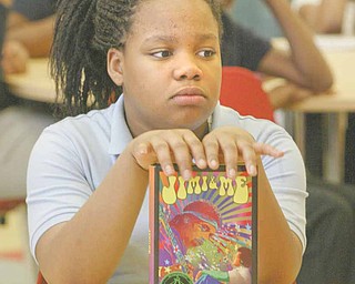 Kelaya Banks, a sixth-grader at Wilson Middle School in Youngstown, holds a copy of author Jaime Adoff’s book “Jimi and Me.” Adoff was visiting with students as part of Right to Read Week.