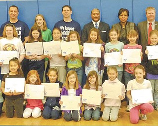 Girl Scouts of Troop 80344, McDonald, show off their individual certificates after receiving the Silver Level President’s Volunteer Service Award for community service.