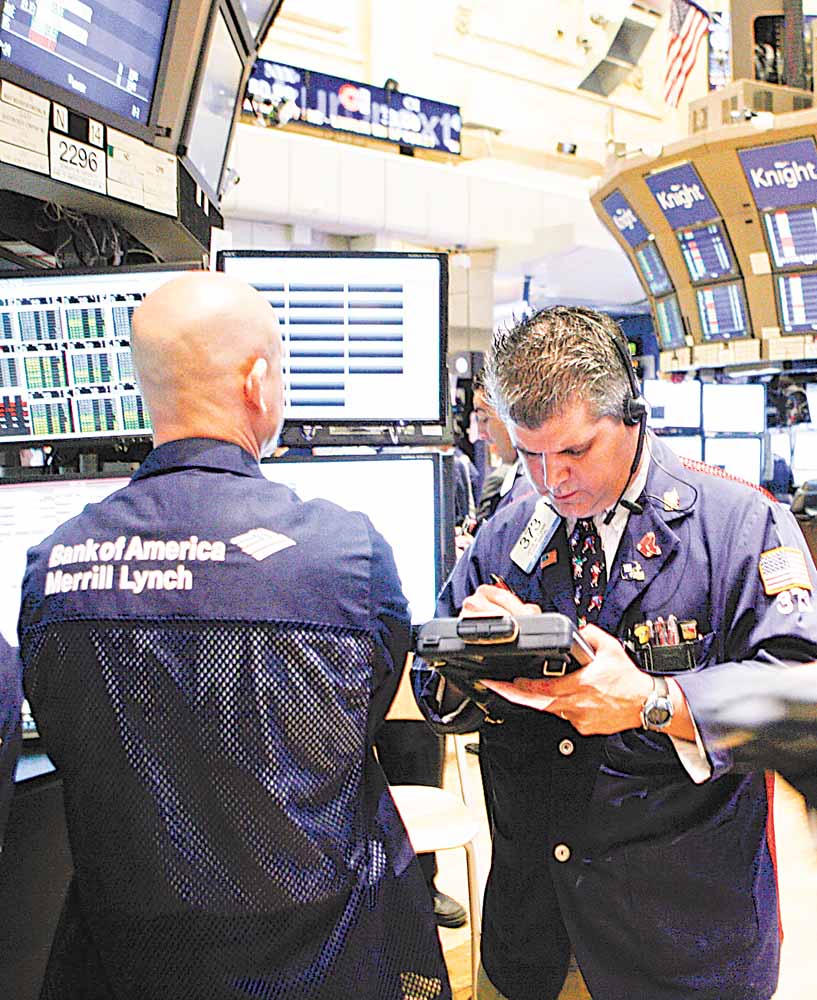 In this May 16, 2011 photo, traders work on the trading floor of the New York Stock Exchange. World stocks climbed Wednesday, May 18, shrugging off weak U.S. economic indicators as Asia got a boost from signs that Japan's post-tsunami recovery is quickening.