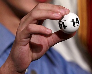 Grant Gilbert, 13, the son of Cleveland Cavaliers owner Dan Gilbert, holds one of the lottery numbers that were drawn in combination giving the Cavaliers first place during the 2011 NBA basketball draft lottery, Tuesday, May 17, 2011 in Secaucus, N.J. 