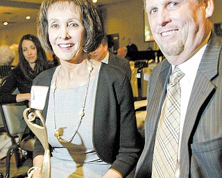 Martha Bushey, with her husband Michael at her side, proudly holds the Athena award. Bushey was named the 2011 Athena winner during a banquet Thursday at Mr. Anthony’s in Boardman. The event is hosted by the Youngstown/Warren Regional Chamber and The Vindicator.